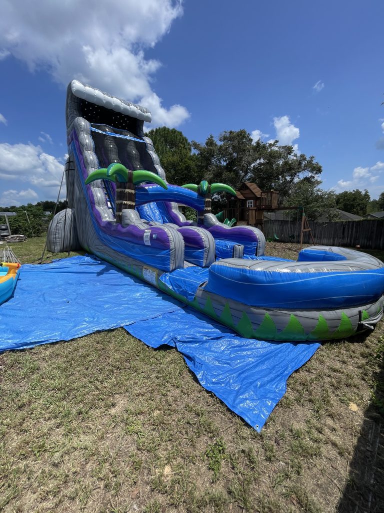 A large dual lane waterslide set up outside on a sunny day.