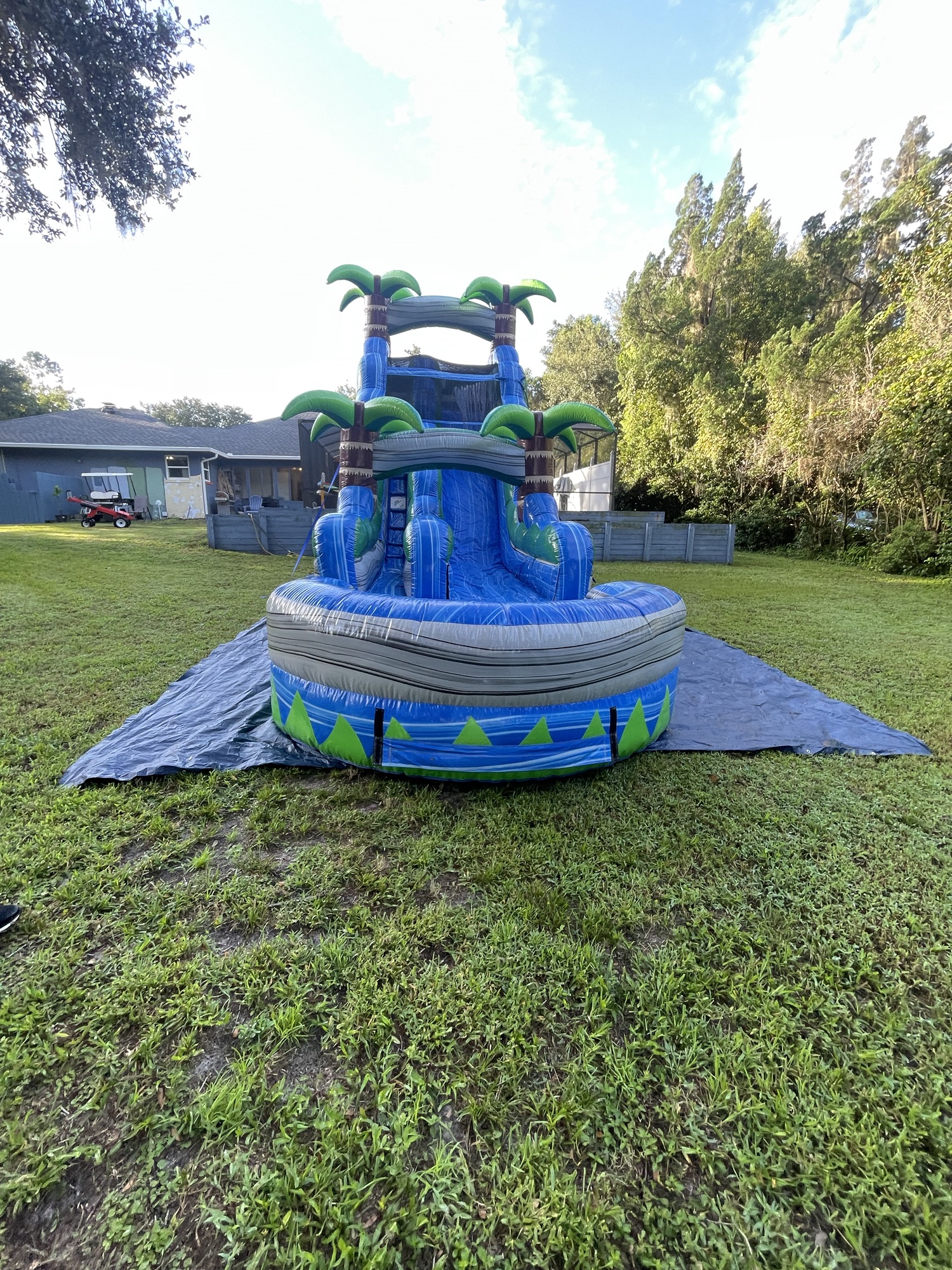 A blue waterslide with a palm tree's set up in Apopka.