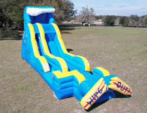 A 19ft giant waterslide blown up outside on grass.