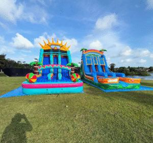 Two double lane water slides set up next to each out with summer vibes and themes.